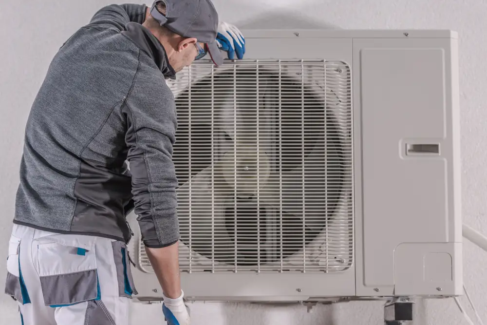 Heat Pump Repair In Vacaville, CA: Understanding and Fixes - Technician examining a heat pump