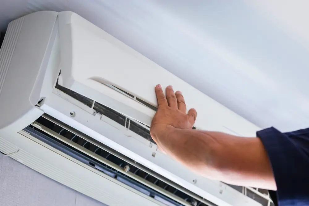 Understanding Ductless Mini Splits: A Modern Heating Solution - Technician installing a ductless mini split